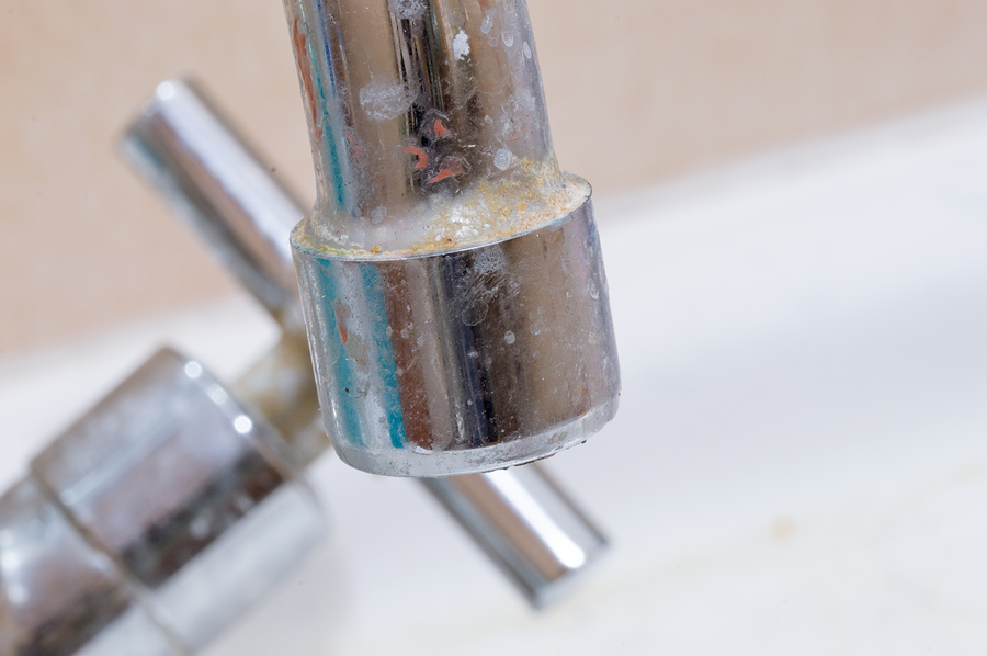 Close-up for water tap with limescale. Calcification of a faucet in bathroom.
